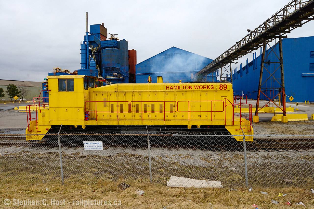 This is the last time I photographed Stelco locomotives in operation, in recent years they switched to trackmobile and the engines do not seem to be used anymore. Framed in the industrial grit of Hamilton, the yellow contrasts nicely. However, I do wish I saw this in orange. Anyone have pictures of this in Stelco paint? We don't seem to have one on the site. Here's a pic from Keith MacCauley who has a number of pictures of Stelco locomotives, including this one of 92 with a couple 'goats' for the pig iron blast furnace cars.