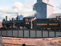 Canadian Pacific 29, one of the three famed 4-4-0s from New Brunswick takes a spin on the table at Saint-Lin-Laurentides, Quebec for its return trip to Montreal where its fire will be dropped for the last time.  November 6, 1960 marked the final day of CPR steam operation (until 2816 in 2001), and the occasion was marked with #29 leading an excursion from Montreal to Saint-Lin, a 74-mile total round trip via the Park Avenue, Ste. Agathe, and St. Lin Subdivisions.  A small ceremony was held near St. Lin Junction as the following day would mark the 75th anniversary of the driving of the last spike at Craigellachie, British Columbia.<br><br>Built at CPR’s <a href=http://www.trainweb.org/oldtimetrains/photos/cpr_facilities/Delorimier.htm>Delorimier Shops (Montreal)</a> in 1883 as A-1-e CPR 390, the locomotive would be renumbered 217 in 1908, and finally 29 in 1913.  After retirement in 1960, the locomotive would be donated to the CRHA, later being sent to the Salem & Hillsborough Railway in New Brunswick where in 1994 it would suffer major damage in a <a href=http://www.railroad-line.com/forum/data/railphotog/2010720145819_CP%2029%20burned%2012%20Oct%2094%20No24.jpg>roundhouse fire</a> caused by arson.  Fortunately, Canadian Pacific recognized the heritage of this locomotive, acquiring it for cosmetic restoration in 1996 and placing it on display at their <a href=http://yourrailwaypictures.com/CPRsteamengines/CP_29-sept18.jpg>company headquarters in Calgary.</a>  With headquarters moving from downtown out to Ogden in 2012, the locomotive remained downtown until June 2017, when it too made the trek to Ogden for cosmetic restoration.<br><br>The 15.1-mile St. Lin Sub was built in 1877 with the first train operating on November 6 of that year (83 years to the date of this photo).  Originally the line had been chartered on December 24, 1872 as the Montreal & Laurentian Colonization Railway, branching off of the Montreal Northern Colonization Railway (later CPR Ste. Agathe Sub) at St. Lin Junction, and was to be constructed after the main line to St. Jerome was completed (October, 1876).  The line was renamed the Laurentian Railway Company on January 28, 1874 and would later be purchased by the eastward expanding CPR on March 13, 1882.  Passenger service ended on March 29, 1956 with the last train being hauled by G-2-s Pacific 2580 and the line would be abandoned October 1, 1963, torn up before year’s end.  The grain elevator behind would survive until late 2016/early 2017, removing all traces of the area’s past uses.<br><br><i>Earl Roberts Photo, Jacob Patterson Collection slide.</i>