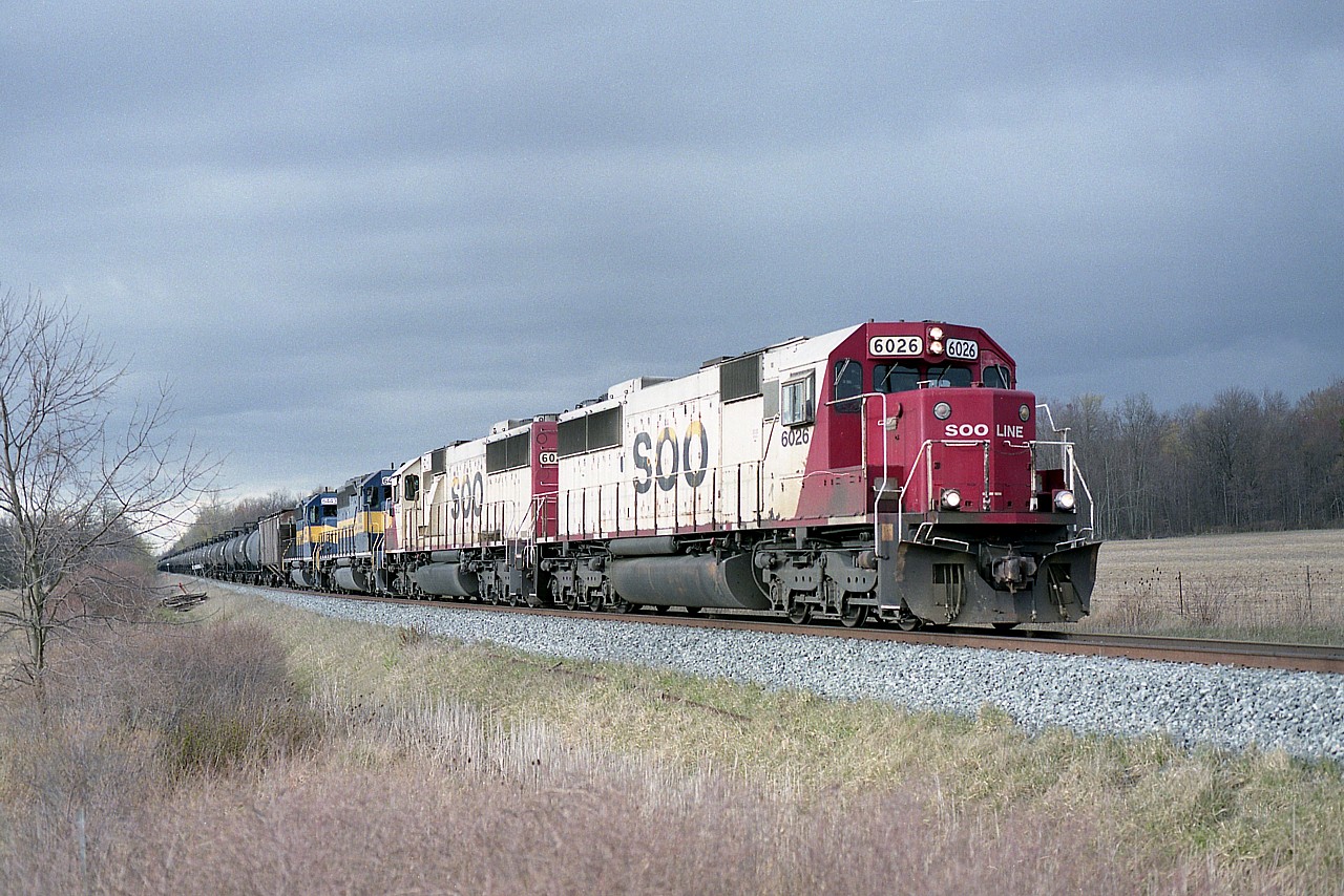 It wasn't all that long ago, but it seems like it was.  We were being treated to great combinations of ethanol train power thru Niagara several times a week. Now.....nothing. What rolls thru on the Galt sub now pales in variety.
An example is this late day version; SOO 6026, 6027, ICE 6458 and 6443 approaching mile 23 Hamilton sub and the Welland River bridge, which after crossing is the entrance to the Welland Yard. The backdrop of threatening clouds adds to the scene.
I refer to the north side of the water as 'Pelham' as municipal boundaries are a bit confusing in the area. The south side of the river here I refer to as 'Welland' even though I understand the Welland Yard is actually in Wainfleet.
SOO 6026 and 6027 are now CP 6301 and 6302. The ICE 6458 and 6443 were sold to the RCPE in 2014. Times change.
Quickly.