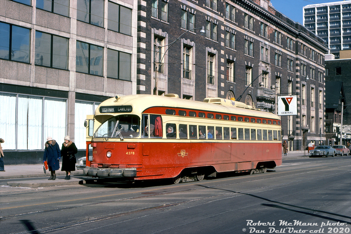 TTC PCC 4378 (an A6-class car built new for Toronto in 1946-47) pauses while on the Carlton route to let patrons off at the northeast corner stop island of College and Bay. It may look like a sunny winter afternoon, but the two ladies disembarking from the streetcar are clearly dressed for the season, and only a few windows on the 4378 are cracked open for some air. The coating of salty road grime was not kind to the TTC PCC fleet over the years, nor the CLRV and ALRV fleets that followed.

The old Central YMCA building in pictured the background, built in 1913 but replaced in the mid-80's by the present-day Toronto Police Headquarters at 40 College St.

Robert D. McMann photo, Dan Dell'Unto collection slide.