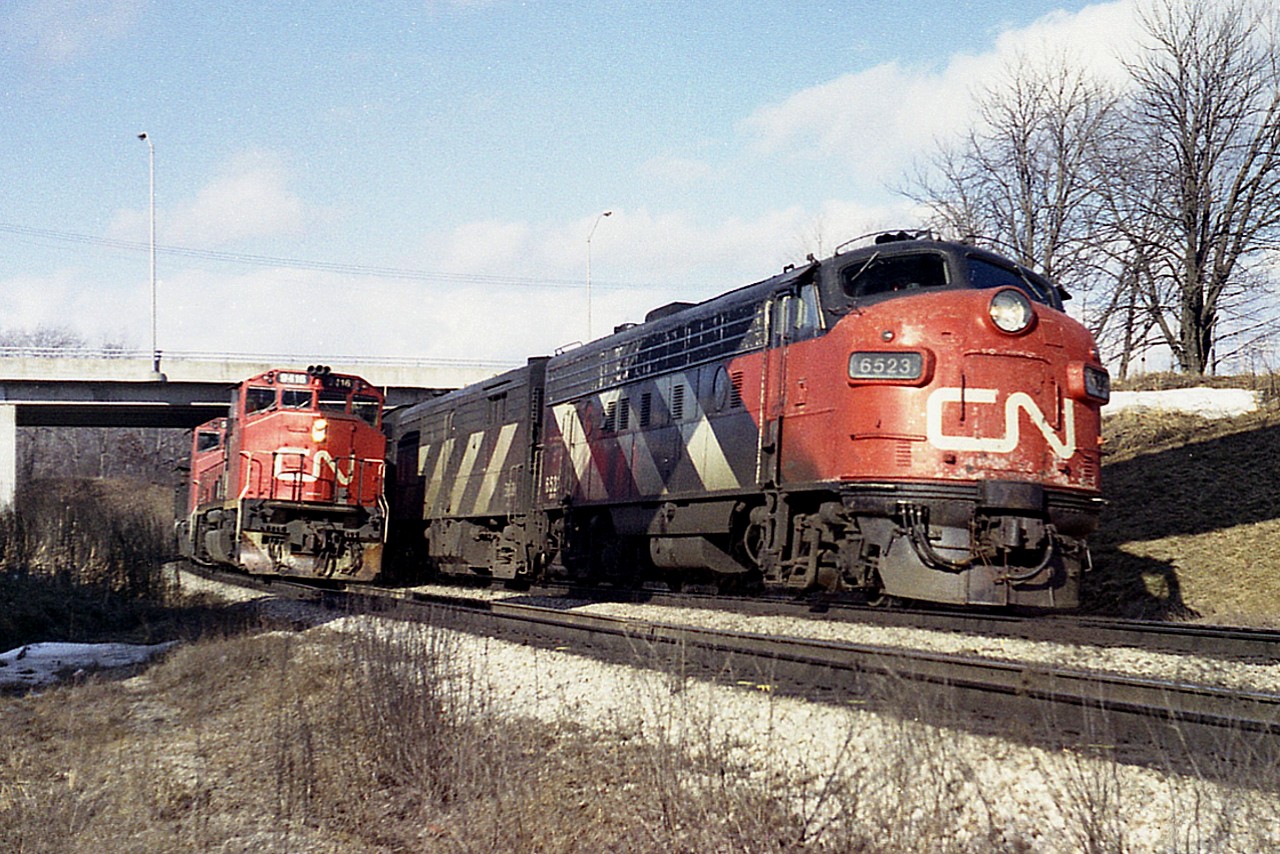Getting on in the afternoon and it is a busy time around Bayview on a rather pleasant Sunday. Here, a westbound freight, led by CN 9416, is held for a more speedy CN (VIA) #75 to overtake and run ahead on the north track, Dundas Sub., as an eastbound freight was occupying the south. I am standing beneath the railfans walkbridge; something that isn't done these days. The 6523 was eventually rebuilt to VIA 6312.