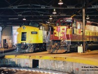 Former VIA Rail FP7A 6553 and Wisconsin Central SD45 6541 share shop space at WC's Sault Ste. Marie diesel facility as both units were in different stages of life. WC 6541 was originally built in 1971 as Burlington Northern, before becoming WC 6541, then re-numbered 7526, before ending its run as NREX 7526. FP7A 6553, which was built for Canadian Pacific in 1953 went on to become Algoma Central FP9A 1756. It was later retired and sold to the West Coast Railway Association in Squamish, British Columbia.