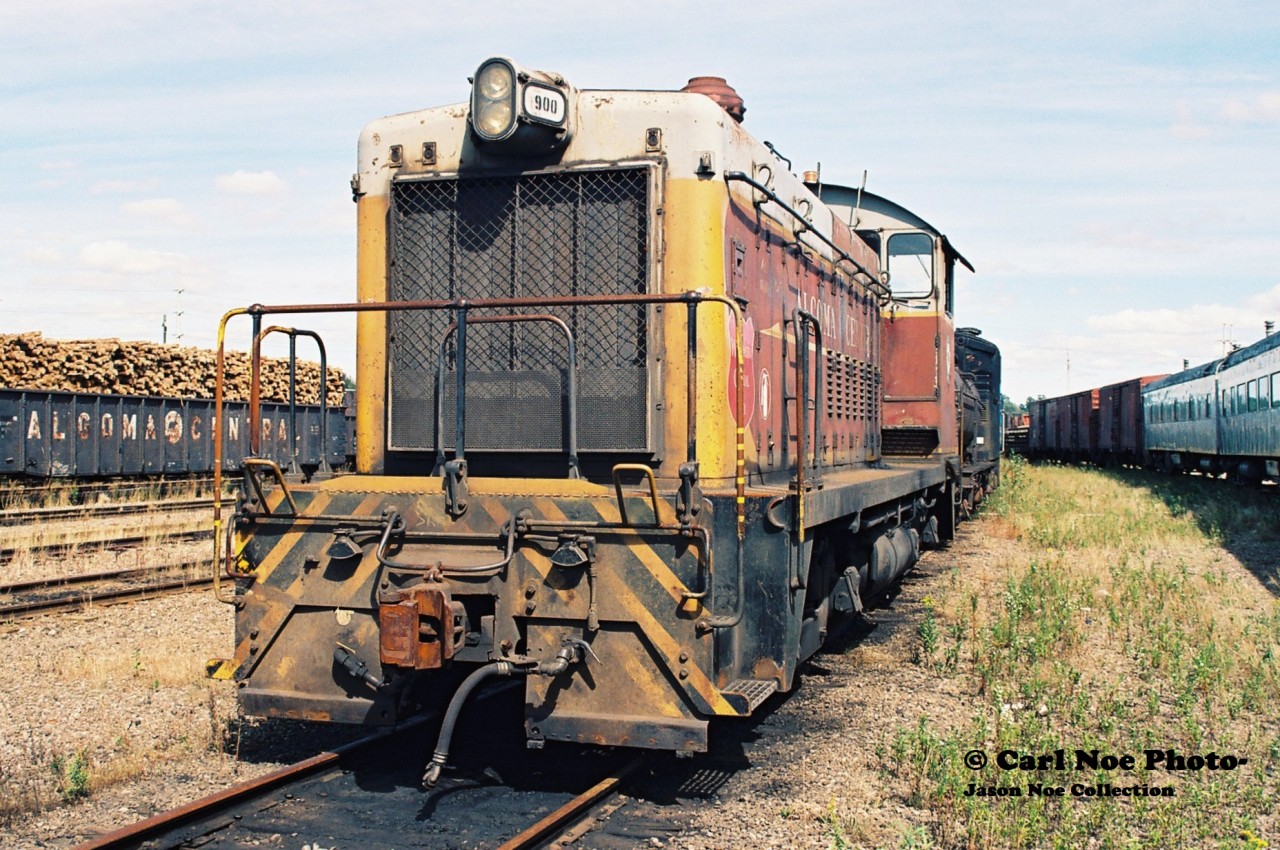Wisconsin Central (WC) SW8 900, which was former Algoma Central Railway (ACR) 140 is seen sitting in WC's Sault Ste. Marie yard. Earlier that year on January 31, WC had acquired the ACR and all of it's locomotives. The SW8 was built by General Motors in December 1951 and was only ever renumbered by WC as well as given WC logo crests as seen in the photo, never receiving a full repainting. It was eventually sold to Independent Locomotive Service and was given an extended career operating as ILSX 900.