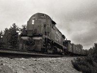 As Extra 3223 slows on its approach to Brent, an isolated crew change point on the northern edge of Algonquin park, two of the crew members poke their heads out of the side window to get their photo taken.  The first car in the consist looks to be a flanger.  The Beachburg Sub was part of the Transcontinental Mainline, built by The Canadian Northern Railway in 1915.  It was abandoned in 1995.