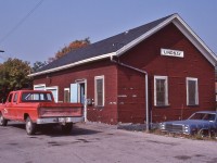 


<br>
<br>
   So, when is a railway building, a station ?
<br>
<br>
   Substituting for the removed passenger station, the express freight shed office handled station duties until the end of rail service.
<br>
<br>
   At the Lindsay Express Freight Shed Station, beside mile zero Uxbridge Sub., September 13, 1982 Kodachrome by S.Danko
<br>
<br>
   Noteworthy Lindsay musings: 
<br>
<br>
   The passenger station removed 1963, after passenger service ended in January 1962
<br>
  Ironically, the largest passenger trains to originate from Lindsay occurred after the passenger service ended and after the passenger station was removed ! 
<br>
   Two fourteen car passenger specials, June 24 and June 26, 1963, Lindsay to Morrisburg, Ontario conveyed students ( June 24) and general public (June 26) to the newly opened Upper Canada Village. ( references:  Keith Hasen, ' Last Train from Lindsay'.) [  the UCV school specials were common in mid sixties]
<br>
<br>
   Worth mentioning:
<br>
<br>
   Perhaps the second largest passenger trains - up to thirteen cars - to call in Lindsay were the several UCRS fan trips: 1963 powered by 6167 (retired 1964) and 1966, 1968 and 1970 (?) powered by 6218. At least two of those trips transited the 55 mile Haliburton Sub (track lifted 1983), powered by SW's north of Lindsay, and other trips transited over the entire Uxbridge and Campbellford Subdivisions.
<br>
<br>
   And perhaps the second last passenger train to visit Lindsay ( and transit the entire Uxbridge & Campbellford Subdivisions )   is the  1977  CRHA  (one way Montreal – Toronto ) trip powered by 6060. 
<br>
<br>
   Per Keith's book the last passenger train to visit Lindsay, the passenger-less Northlander – on a publicity tour, enroute from Belleville's 'Railway Days' celebration – stopped at the express freight shed station May 27, 1978 ! 
<br>
   Interestingly the ( express freight shed) station agent position survived to November 1980, meanwhile CP only occasionally entered Lindsay with abandonment in 1987 – I do recall seeing a CP Rail SW in Lindsay in '85.
<br>
  After the 1989 closing of the  Union Carbide plant in Lindsay, CN got its way, the last train rolled out of town in 1991. All rails throughout Lindsay ( & surrounding countryside)  pulled in 1992.
<br>
<br>
 <a href="http://www.railpictures.ca/?attachment_id= 15760">  6060 on the Campbellford  </a>
<br>
<br>

