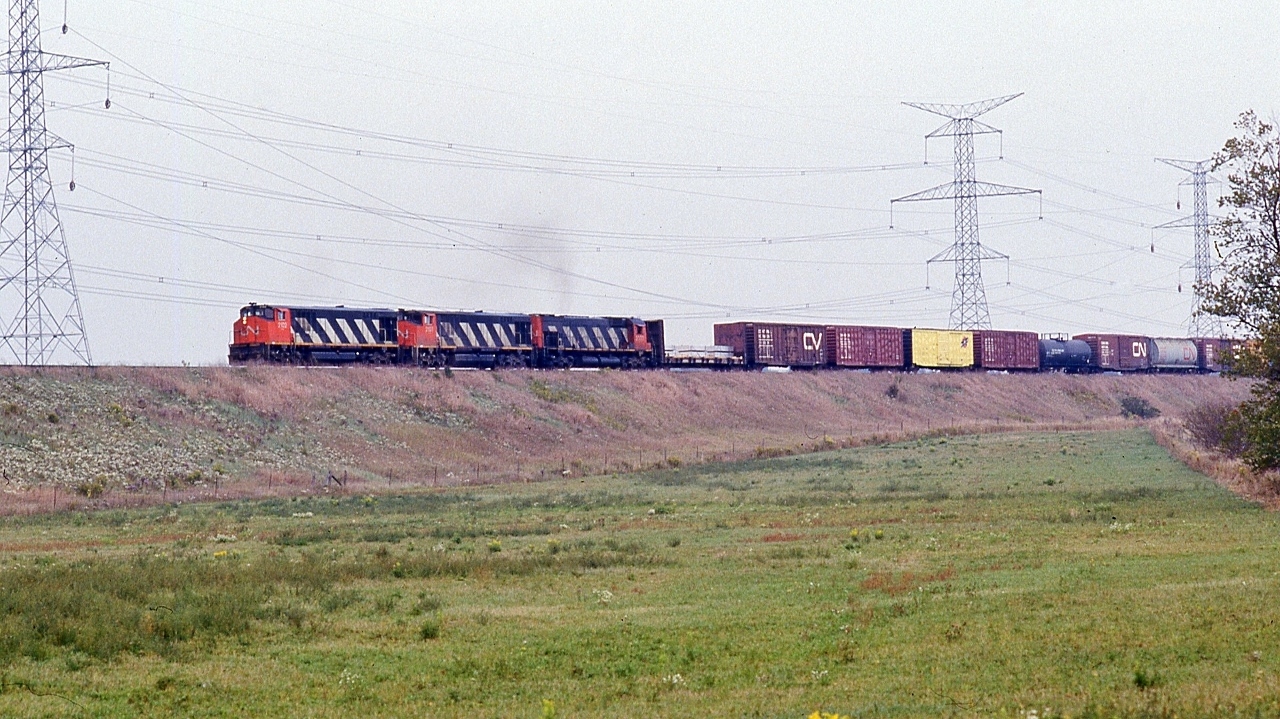 Two BBD and a MLW top the grade, exiting the Rouge Valley


 On the approach to McCowans, York Sub,  CN 2102 west with  2107  and  2337  are down to a crawl and about to pass over the CP Rail Havelock


 Motive power models:   HR616  -  HR616  -  M-636  


 at the Ninth Line,  October 1, 1988 Kodachrome by S.Danko


 noteworthy: the variety of motive power ! 


 All retired / sold  by the mid nineties: 2102 was the 7002 demo on CP Rail; 2107 to NRE.


 that C&NW box really stands out !


 More BBD


    The Demos