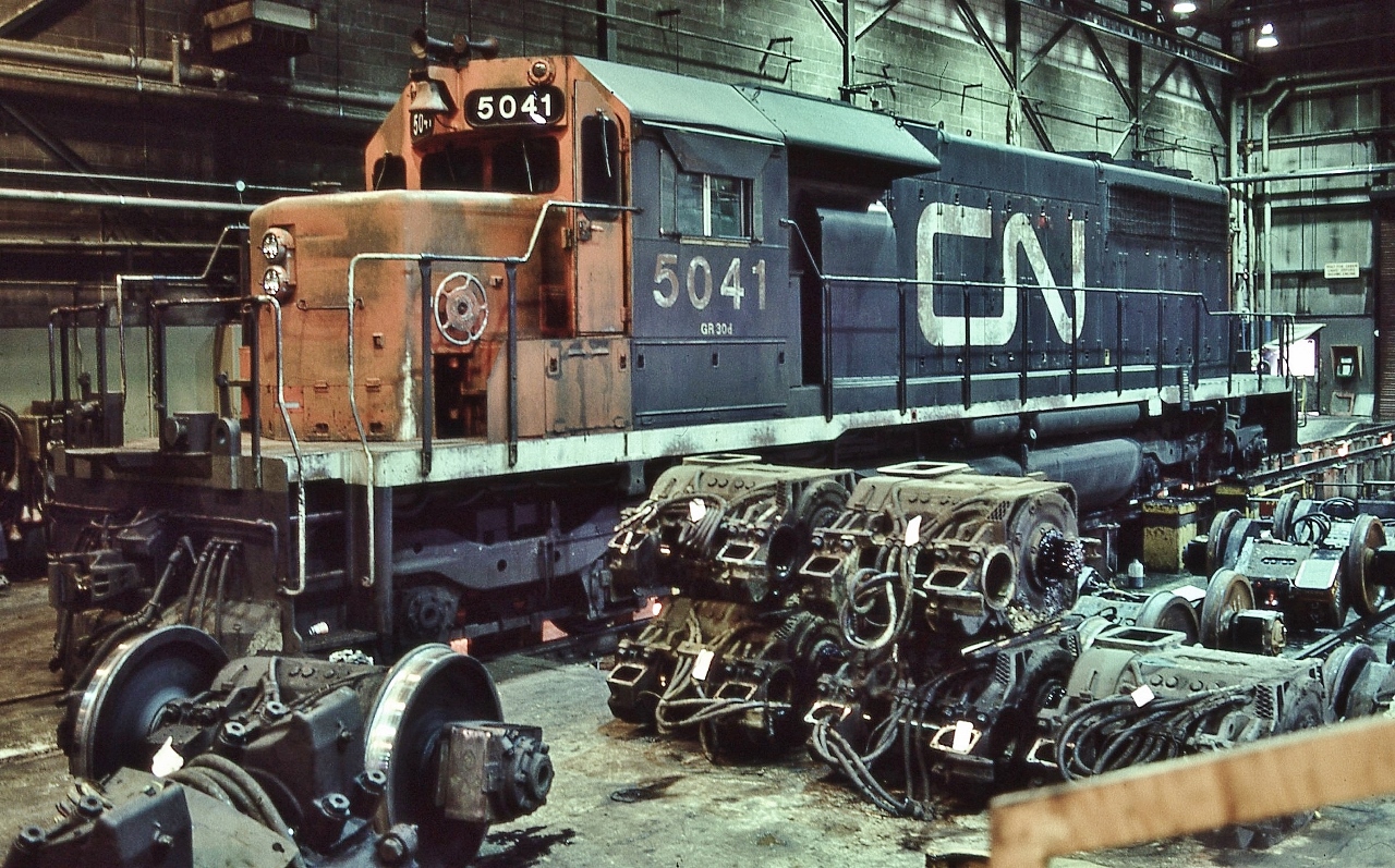 SD40  CN# 5041 at the drop pit: traction motor service time


   CN Mac Yard shop March 1, 1981 Kodachrome by S.Danko


   Noteworthy: CN 5041, GMD 1968, sold in 1999 and re-manufactured to SD40-2 standards: purchased by BNSF, along with 36 sisters, numbered in the BNSF 7300 to 7339 series.