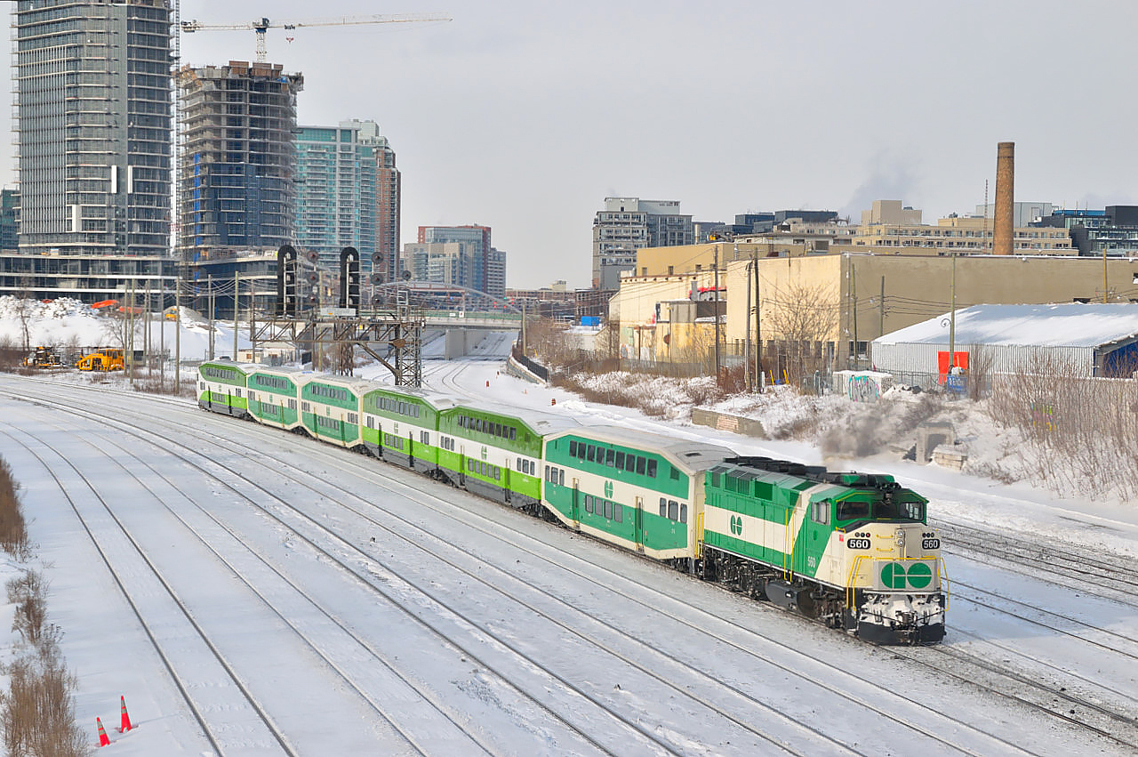 Gentrification continues reaching skyward in the big smoke, and after bringing another bunch of commuters into town GO 560 shoves it's empty consist westward from beneath the Bathurst Street bridge leaving the USRC behind for a rest at Willowbrook.  About an hour earlier the junction laid fully in the shadows of one of the many condos surrounding the area.