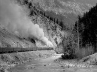 Train no. 4 with R class helper and T1b road engine west of Leanchoil in lower Kicking Horse canyon.  Engine numbers unknown.