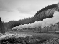 Train no. 4 with R class helper and T1b road engine west of Leanchoil in lower Kicking Horse canyon.