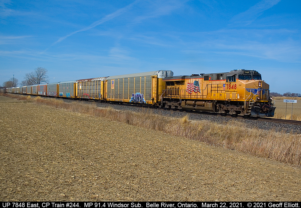Union Pacific 7848, running solo, leads a massive empty autorack train, CP Train #244, as it rolls past the westbound Belle River Mileboard on March 22, 2021.