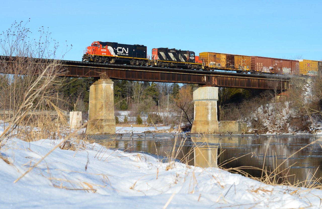 The geese in the cold Grand River are startled as CN L540 flies over the bridge in Breslau at a very well maintained speed with GTW 6226 and CN 4028 for horsepower. Unfortunately in a photographer’s perspective, this bridge is now slightly less appealing as railings were placed on both sides permanently by Metrolinx for general safety purposes. Although I missed out on plenty GEXR opportunities here, I still managed to get a few with CN this being my only one with a good amount of snow which looks great with the water. As for 6226, this unit is now assigned to the Ottawa area and for some reason Kitchener was the only place it was based out of in this part of Ontario and not for long either.