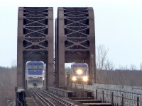 EXO train number 81 returns from its trio to Candiac while EXO 85 is heading there. The EMD F59PHI is the engine used for this line as both trains have them pushing/pulling. We see them crossing the CP LaSalle Bridge over the Saint-Lawrence river.