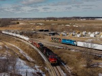 CN A40231-06 meets CN L58031-06 at Caledonia on a sunny yet cold March afternoon.  580 had run to CGC earlier in the day to lift 15 loaded centre beams from the plant and was sitting in the clear on the old Rymal Spur to meet 402 with a small 9 car train.  This is probably the first meet on the line since CN last held control of it.