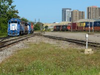 On a sunny summer morning, a CN 149 with a pair of EMD’s rolls into London with their train of double stacks for Chicago as 2 double sets of yard power sit unassigned on the west end of London Yard consisting a blue GMTX leaser on both sets. The GMTX 2695 / CN 1439 would be taken on 439 to Chatham for 514 the next day. 