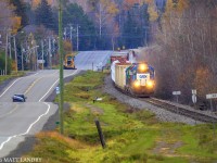 Out of Fredericton Jct, train 907, in the distance, approaches Tracy, New Brunswick. 