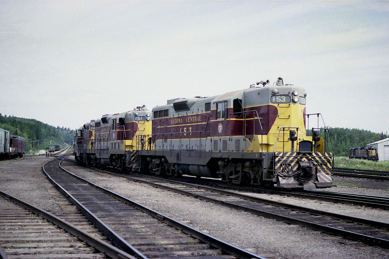 Stopping in at Hawk, it was nice to see three of the original first diesels of the Algoma Central. The lot was GP7 #150-154 and here we see 153, 151 and 152. Note the enginehouse on the extreme right and the track of the Michipicoten sub on the distant left.
The AC 153 was gone by 1981, it went to Michigan Northern as their 1603, then to Maple River Transfer (Pellston, MI) and was eventually scrapped at the Ohio Central in 2004.
AC 151  was sold (along with 150) via a dealer in 1981 also, and went to the Keota-Washington Transportation, a short stretch of track that became available in Iowa upon the demise of the Rock Island Railroad. The "Kewash" didn't fare so well, being abandoned by 1988.
As for AC 152, it didn't fare well at all either. It got itself scrapped in 1980.

Hawk Junction was an interesting place to visit at one time. Now; under CN,  there is little remaining.