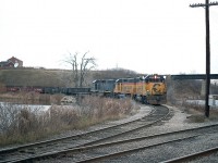 A late afternoon image of the TH&B version of the Nanticoke steel train on approach to the CASO from the Waterford sub. This is the west end of the wye.
By the following January the bridge in background was redecked as a more efficient method of accessing the CASO.   http://www.railpictures.ca/?attachment_id=38474
Power on this train was B&O 4801, C&O 3885 and 4828.
