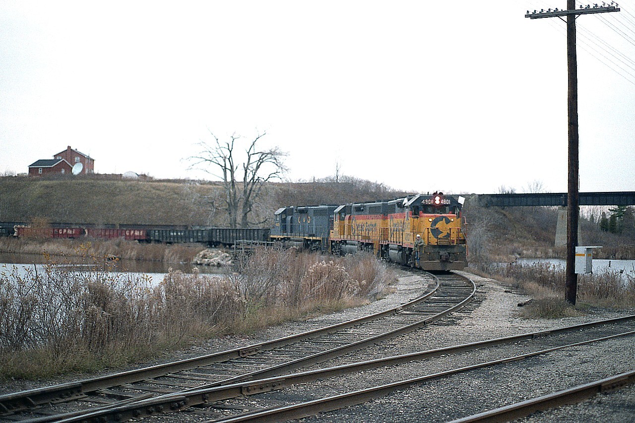 A late afternoon image of the TH&B version of the Nanticoke steel train on approach to the CASO from the Waterford sub. This is the west end of the wye.
By the following January the bridge in background was redecked as a more efficient method of accessing the CASO.   http://www.railpictures.ca/?attachment_id=38474
Power on this train was B&O 4801, C&O 3885 and 4828.