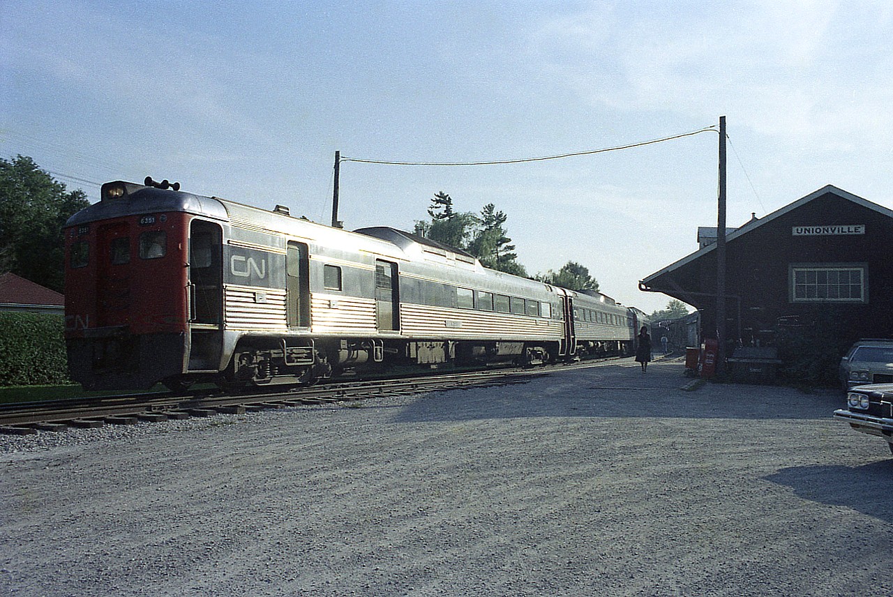 Decided to offer this image up, as it appears BUDD cars are making the news these days.  The sun is low and the angle extreme, but the light off the sides of the Budds gives this image some appeal.
Hard to imagine why such efficient looking transportation would go the way of the dodo.  A real shame. This run, a Monday-Friday commuter from down in Toronto to Stouffville is patronized well enough that it requires four Budds on the journey. It looks to me later than the 1800 hrs scheduled stop at Unionville 20 miles into the northward run, but then there are a lot of buildings around to block the low sun.  Power consists of CN 6351, 6001, 6006 and 6401.