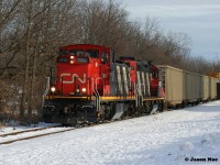 For whatever reason, GMD1's do not seem to last long once they are assigned to Kitchener. However, during a brief period early this year, CN 1412 found its way to Kitchener where it operated on assignments for a short time between January and early February.
<br>
While most days during those two winter months were filled with seemingly endless clouds and snow, there were some moments of sun. Luckily 1412 caught one as it and GP9RM 4102 led L540 as they returned from the CP interchange in Kitchener approaching Queen Street on the Huron Park Spur. 
