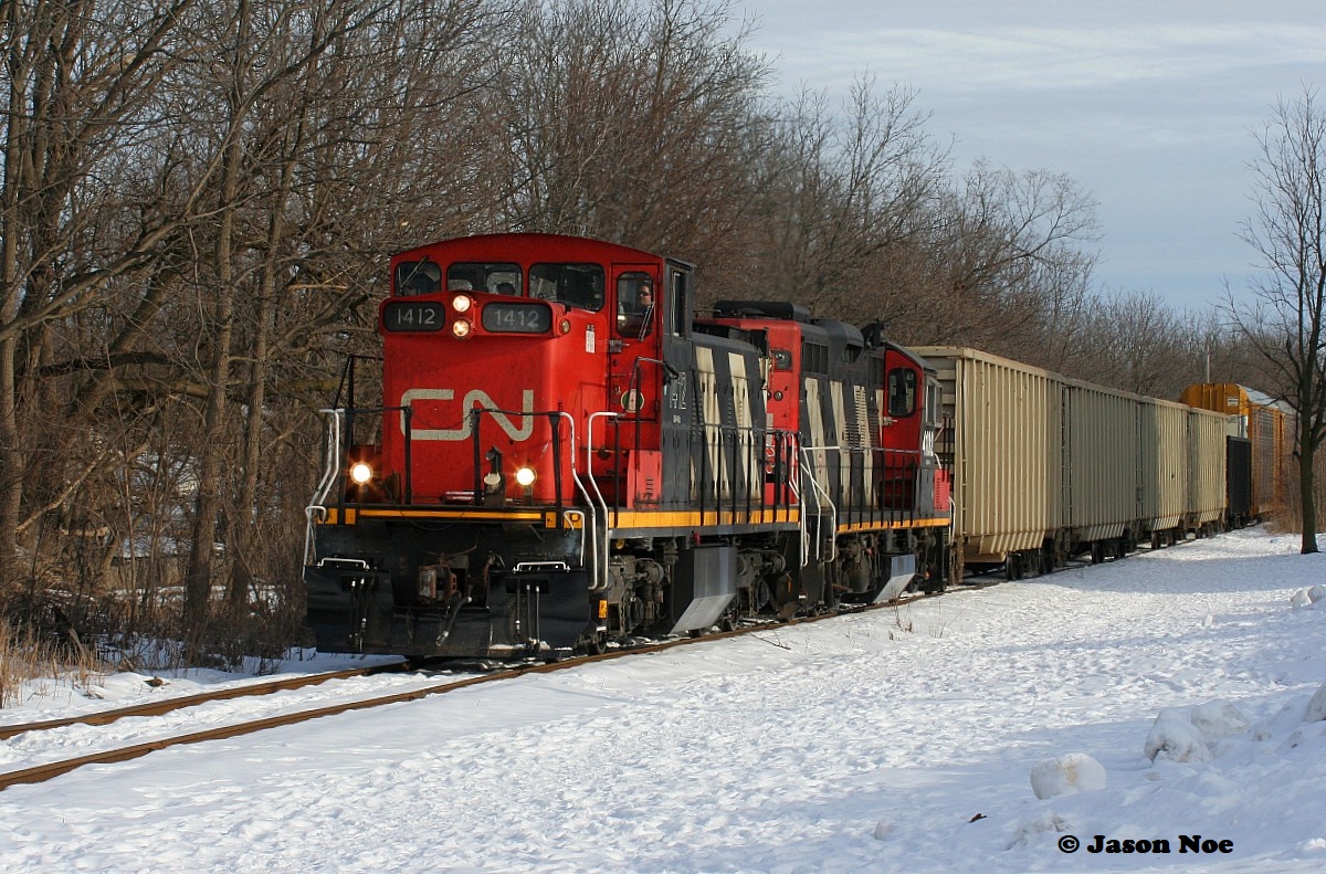 For whatever reason, GMD1's do not seem to last long once they are assigned to Kitchener. However, during a brief period early this year, CN 1412 found its way to Kitchener where it operated on assignments for a short time between January and early February.

While most days during those two winter months were filled with seemingly endless clouds and snow, there were some moments of sun. Luckily 1412 caught one as it and GP9RM 4102 led L540 as they returned from the CP interchange in Kitchener approaching Queen Street on the Huron Park Spur.