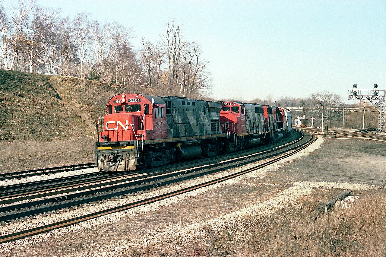 CN 3201, 9504 and 9554 power a train westbound into the long climb to Copetown. The leader, an MLW C-424, is of interest because it and 3200 were the first two of a series of C-424s to operate on CN, having been built in 1964 and the balance of the 41 units total built in 1966-67. I rarely caught either of the first two of this series leading. The 3201 was retired in 1985.
