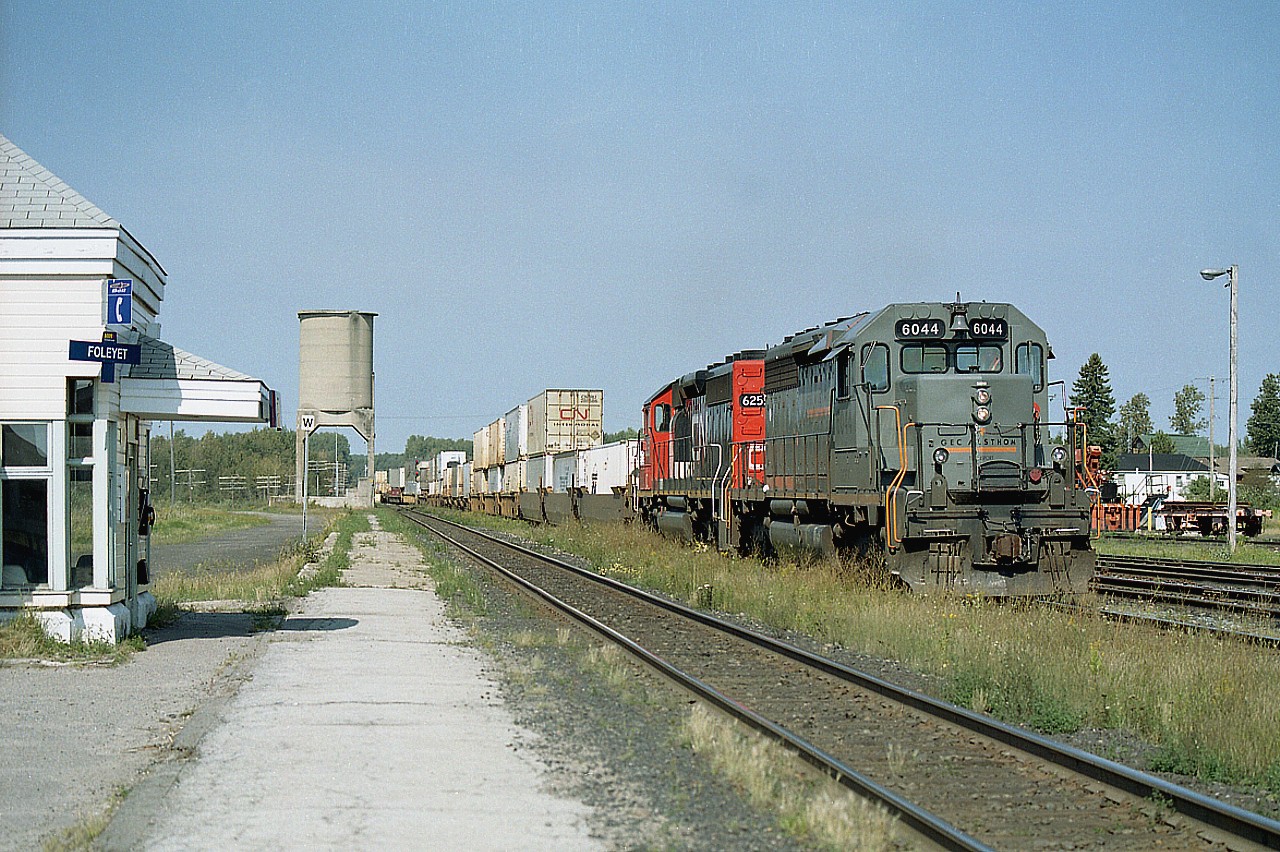 Southbound CN train seen passing the old Foleyet VIA waiting kiosk, as it slows in for a stop. Lead unit is Connell Finance Co's GEC Alstom locomotive  #6044, which is on lease to CN. This unit was a former CN SD40 #5143, which was then sold, went for a rebuild in 1997 and emerged as an SD40-3. Trailing unit is IC 6255. I'm wondering if the old tower is still standing.............