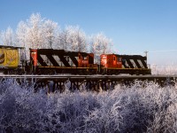 At 10:40 on a cold January morning, 584 is heading out with a long string of grain hoppers to peddle at the various elevators on the way.