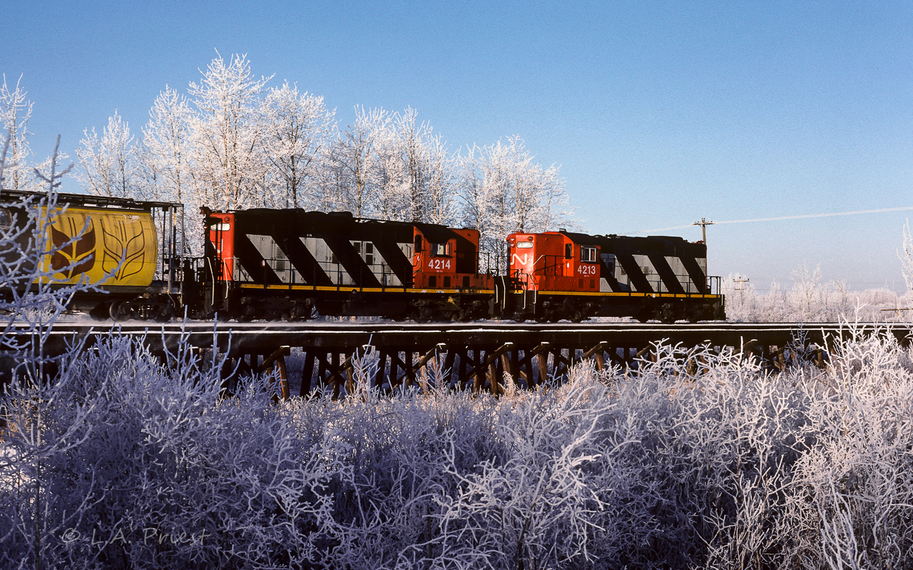At 10:40 on a cold January morning, 584 is heading out with a long string of grain hoppers to peddle at the various elevators on the way.