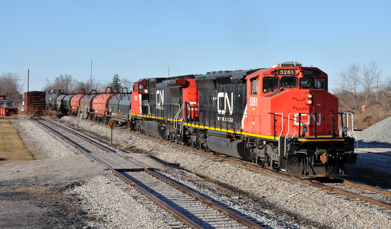 A rather late A40131 20 makes their way through Hagersville with CN 5261 and CN 2195 in charge of their 21 car train. 5261 was one of two SD40-2W's (5258) converted for experimental Natural Gas operations in the early 2010's