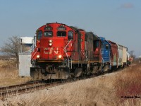 CN L568 with 7081, 4730 and GMTX 2284 are just west of the town of Baden, Ontario, which can be seen in the background to the left. The crew has just uncoupled from their train and are about to switch the two industries located around New Hamburg on the CN Guelph Subdivision. March 27, 2020. 