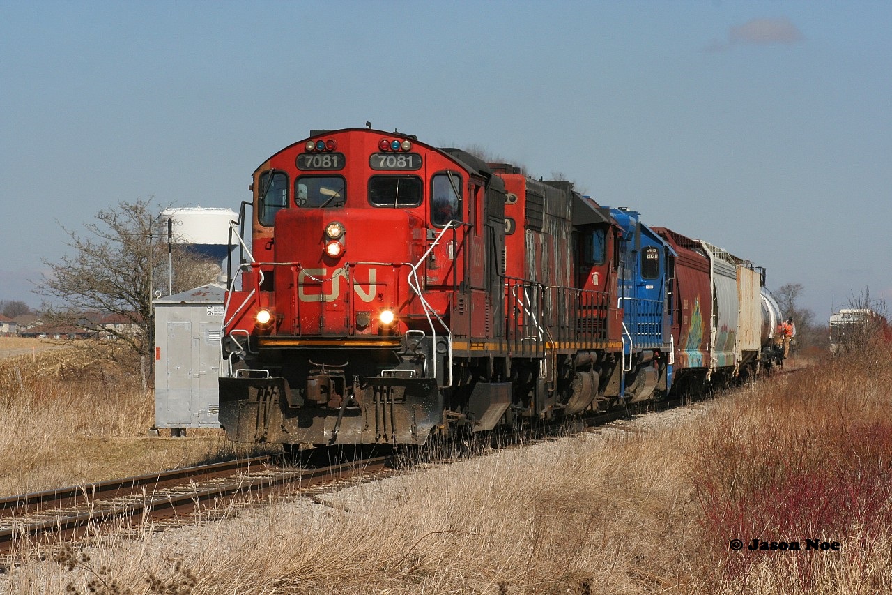 CN L568 with 7081, 4730 and GMTX 2284 are just west of the town of Baden, Ontario, which can be seen in the background to the left. The crew has just uncoupled from their train and are about to switch the two industries located around New Hamburg on the CN Guelph Subdivision. March 27, 2020.