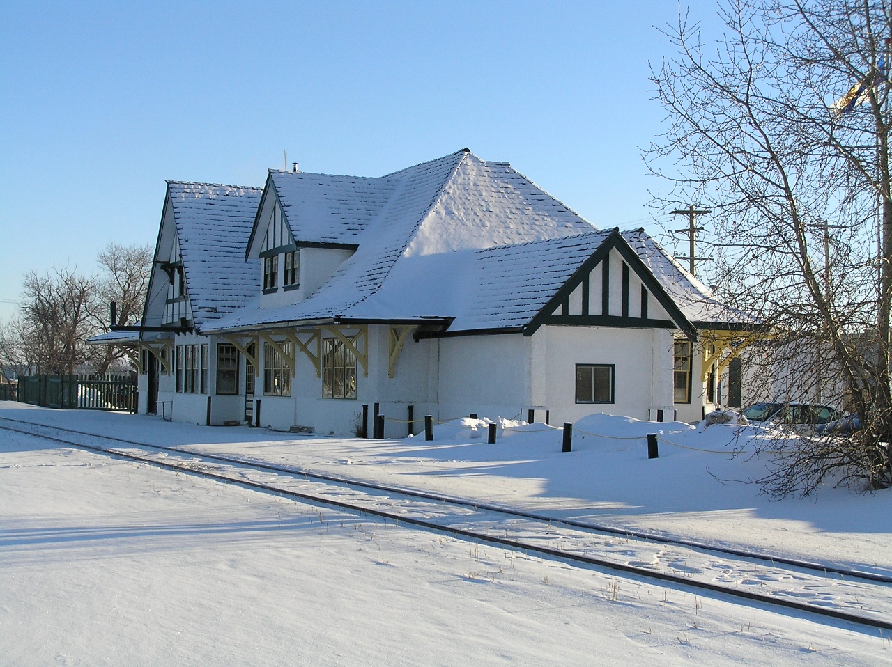 This photograph was taken shortly after I had moved to a VERY small town north of Vegreville AB! All I can remember is that I had stopped to photograph some CN locomotives that were waiting for clearance to proceed on to LLoydminster AB. The locomotives had stopped near a convenience store which was a perfect spot for the crew to use to their advantage.  (foot prints in the snow do not lie) The sky was clear and the temp. was VERY cold, but by being the ex-army type that I was I immediately got out of my van and photographed the locomotives, and the nearby retired CN station. The station was used as a restaurant at the time. The attached photograph is the track side elevation of the station.