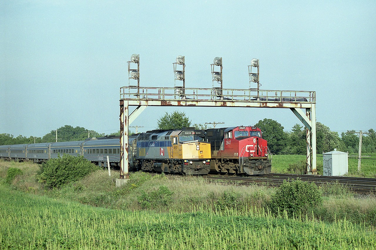 One of those "you had to be there" sort of images. CN 2647, 5424 and 2410 as #385 moving slowly westward under the large signal bridge at the west end of the Paris yard, and along comes, VIA #77; lickety-split. One of those shots you often hope for, but rarely get.  Nice evening sunshine to go with it.