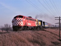 Forty-two years ago VIA Number 1, behind CP 1407, VIA 8558, and an unknown ex CN steam generator car make good time as they head north on CN's Newmarket Sub.  The days were getting longer and warmer, but nothing had turned green!