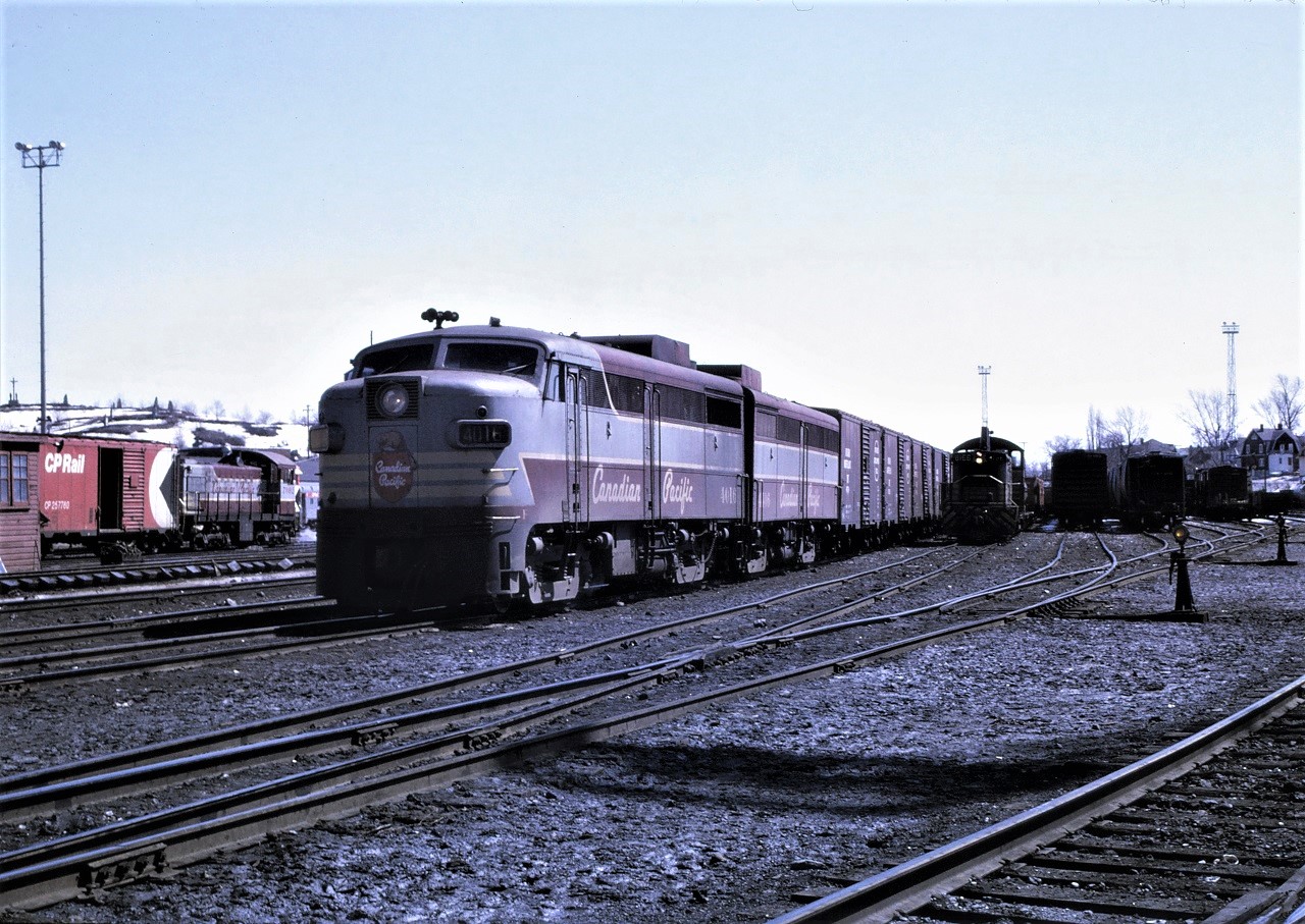 A CP freight lead by 4016 and 4406 has just arrived in Sudbury, Ontario.  Looking on are S-2 7092 and SW1200RS 8168.  Snow is still evident in this mid-April photo as is the scale house and scale track.