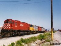 A CP consist is heading towards their train that was assembled on the departure tracks at CP’s Toronto yard. The unique lash-up included VIA Rail 6458, CP 5608, VIA Rail 6452 and CP 4742. At the time power short CP was leasing anything they could. Also, the big 6 had just been un-retired during that winter when the railway had re-activated the remaining operable big MLW-built fleet due to the growing motive-power shortage. 
<br>
This was the only time we were fortunate to see a CP big and leased VIA F40’s together and we almost missed it as the power set had quietly departed the shop area. We were able to catch-up to it along the parallel road before they coupled to their train. It is likely why the photo has some motion blur as there unfortunately was not much time to set-up.
<br>
This was likely a 900-series junk train that was destined for the Belleville Subdivision and ultimately for Montreal. Hopefully, some others to the east photographed it that day as well.
