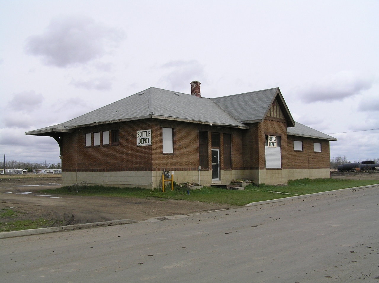 The CPR station in Vegreville is located about 2 blocks from the CNR station. Currently there are no tracks anywhere near it and it is currently being used as a bottle depot. The interior has been modified slightly, but a lot of the original features are still there. It's foot print is smaller than that of the local CN station.
Track wise, the the CPR Vegreville station was located at the south end of a branch that came down from the village of Willingdon AB. Only two railway related structures remain from the abandoned branch lines use. One is the Vegreville station and the other is grain elevator used by a local Warwick farmer.
