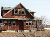 I remember asking the village secretary what happened to the old CPR train station that served Myrnam in the old days. I was sure she would tell me the building was demolished many years ago, but to my surprise she said it's still around and sitting (in two pieces) on a farm just north of town. After getting permission from the farmer I drove up to the site. However getting to the actual building was interesting. I had to slide under the gate while avoiding the many existing cow patties before I could walk up to the building. The fact that the farmer had intended to make a new residence by modifying the old Myrnam CPR station was clearly illustrated by the new concrete foundation it sat on. Unfortunately the local youth had some parties there and as a result did some major damage to the interior and exterior fixtures. The farmer asked me not to divulge the actual location and I have not. The GPS numbers are for the station's actual/original location in town. The station was built as a "CPR western lines standard A-3"station.

 