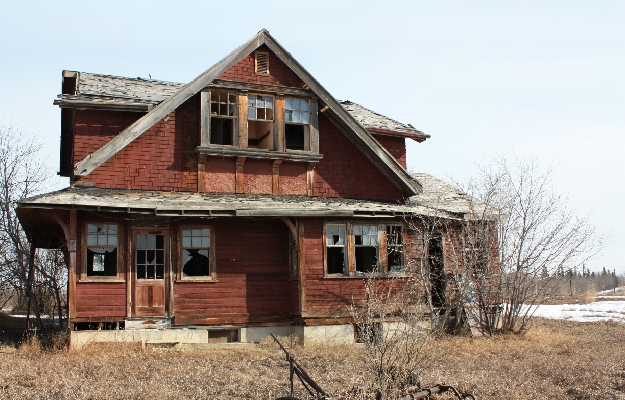 I remember asking the village secretary what happened to the old CPR train station that served Myrnam in the old days. I was sure she would tell me the building was demolished many years ago, but to my surprise she said it's still around and sitting (in two pieces) on a farm just north of town. After getting permission from the farmer I drove up to the site. However getting to the actual building was interesting. I had to slide under the gate while avoiding the many existing cow patties before I could walk up to the building. The fact that the farmer had intended to make a new residence by modifying the old Myrnam CPR station was clearly illustrated by the new concrete foundation it sat on. Unfortunately the local youth had some parties there and as a result did some major damage to the interior and exterior fixtures. The farmer asked me not to divulge the actual location and I have not. The GPS numbers are for the station's actual/original location in town. The station was built as a "CPR western lines standard A-3"station.