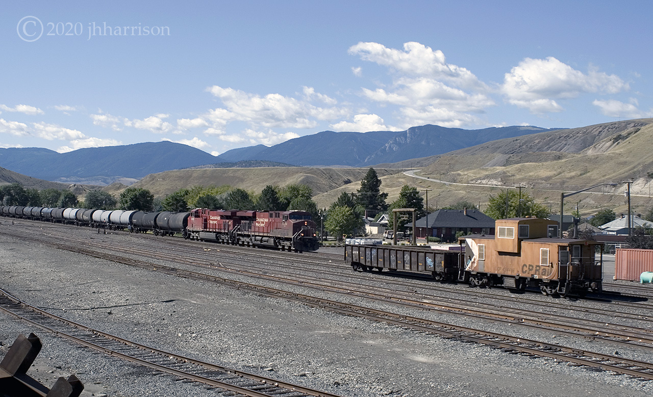 Eastbound CP 8724 and 9362 travel through the yard at Ashcroft on CPs Thompson Sub. The resident caboose is #434418.