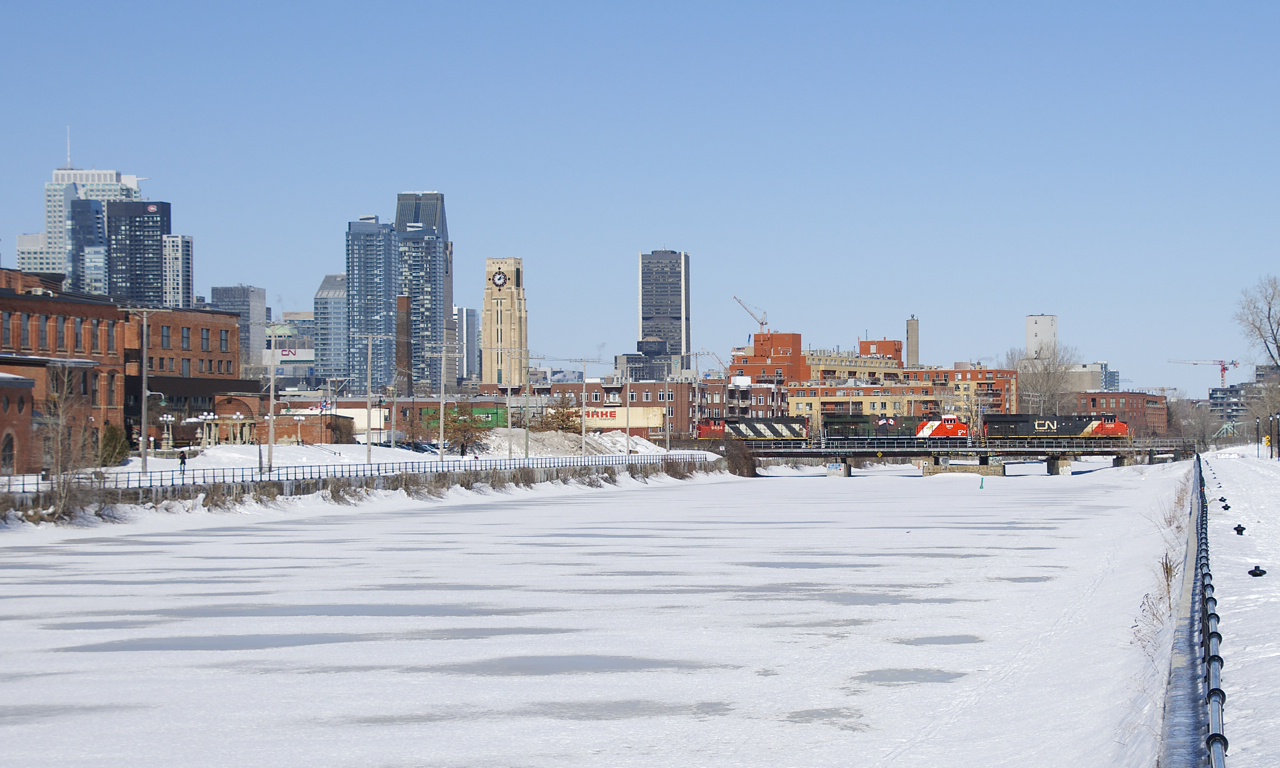 A late CN 120 is crossing over the Lachine Canal with CN 3035, CN 3015 & CN 9454 up front. CN 3015 wears a special paint scheme paying tribute to veterans and active members of the military.