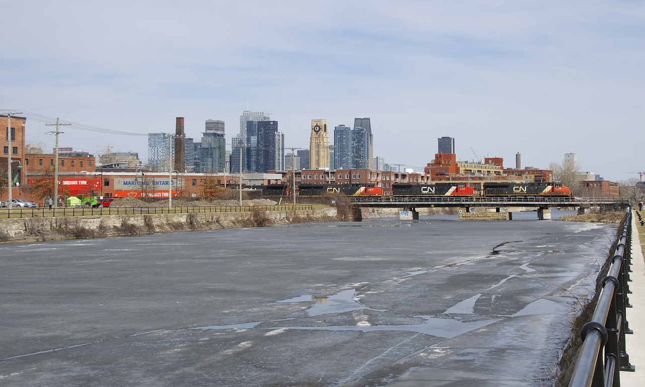 CN 120 has four GE's up front (CN 2299, CN 2153, CN 2972 & CN 2692), all different models, as it crosses the still slightly ice-covered Lachine Canal.