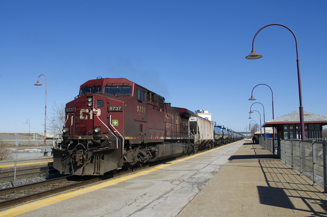 CP 9737 brings up the rear of CP 650 as it passes through the EXO Dorval Station with 98 ethanol loads for Albany. Up front is CP 8620.