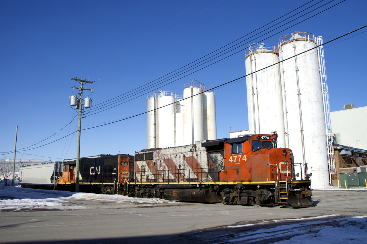 The Pointe St-Charles switcher is respotting a plastic pellets car before departing the Turcot Holding Spur light power. They had just brought a boxcar to the Kruger plant, out of sight to the left here.
