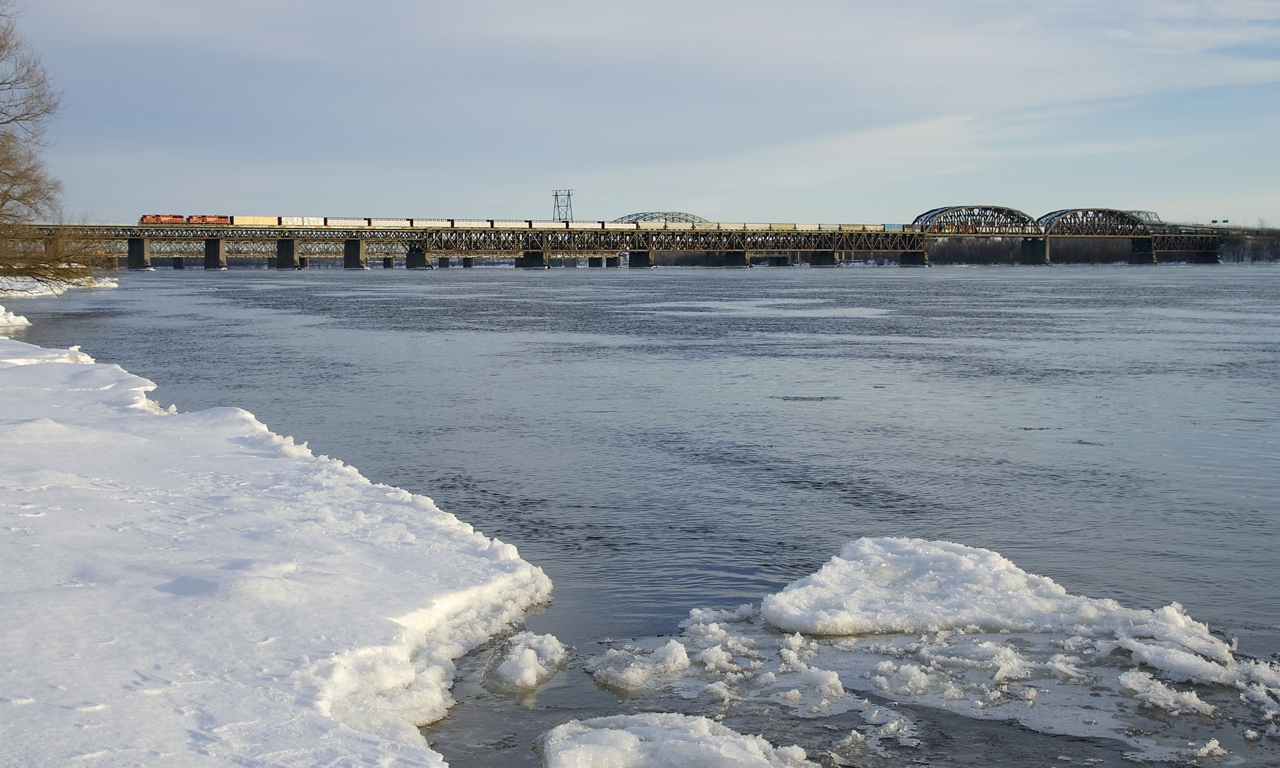 A pair of SD60M's (CP 6258 & CP 6262) lead CP 251 over the St. Lawrence River a bit before sunset.