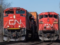 CN 148 with CN 8954 cruises by CN A402 with the CN 2415 leading at Hardy Road in Brantford.  402 had to hold at Hardy to wait on CN L580 to clear the Hagersville Subdivision before they could head down to Garnet.  Shot a 200mm from the public crossing.  Also on my lunch break!