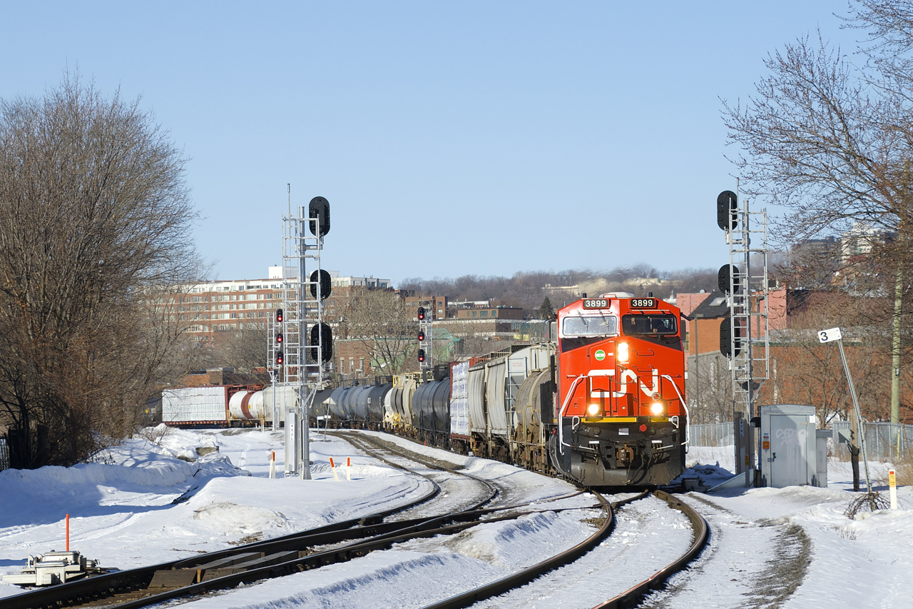 A long CN 322 is passing MP 3 of the Montreal sub; nearly at its destination of Southwark Yard. Up front is CN 3899 and mid-train is CN 2803.