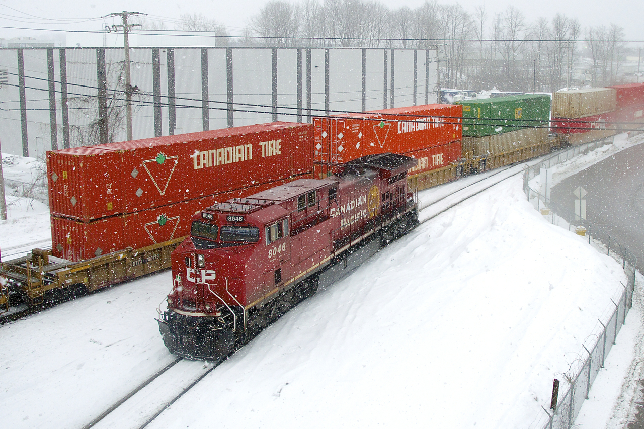Canadian Tire is a big client of CP's and here some of their container passes CP 8046 as CP 112 works Lachine IMS Yard as the snow falls.